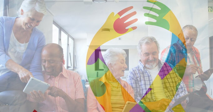 Image of colourful puzzle pieces ribbon over senior friends using tablets