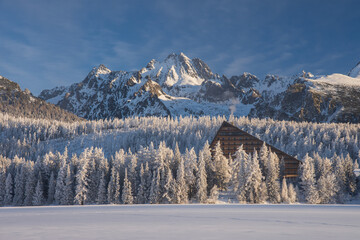 Popular hotel in Strbske pleso, High Tatras, Slovakia. Frozen lake in the foreground with...