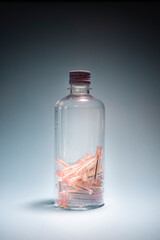 Groups of used hypodermic needles in a clear vial. Environmentally safe disposal of infectious waste.vertical image.