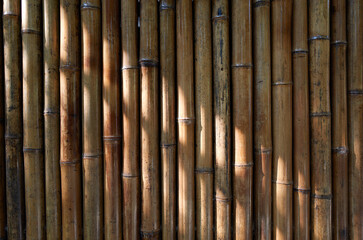 An image of a wall made of bamboo.
