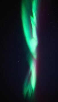 Moments before a substorm on March 3rd, 2024. The aurora forms colorful, dancing and rapidly moving pillars beneath a dark starry sky.