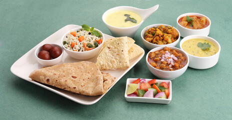 Assorted indian food for lunch or dinner, rice, lentils, paneer butter masala, palak panir, dal...