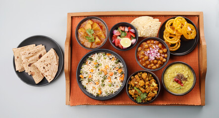 Assorted indian food for lunch or dinner, rice, lentils, paneer butter masala, palak panir, dal makhani, naan, green salad