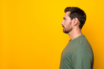 Photo portrait of attractive young man profile look empty space wear trendy khaki clothes isolated on yellow color background