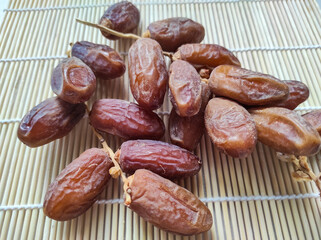 dried dates on wooden background