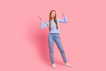 Full size photo of satisfied woman dressed blue shirt jeans raising palms up announcing sale empty...