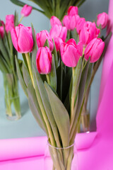 A bouquet of pink tulips on a pink background.