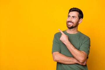 Photo portrait of attractive young man point look empty space wear trendy khaki clothes isolated on...