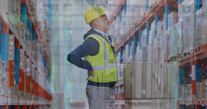 Image of data processing over caucasian male supervisor holding his back in pain at warehouse - Powered by Adobe