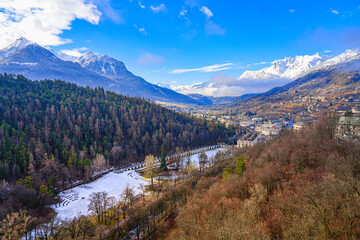 Aerial view of the frozen lake of the Parc de la Schappe surrounded by snow capped mountains in...