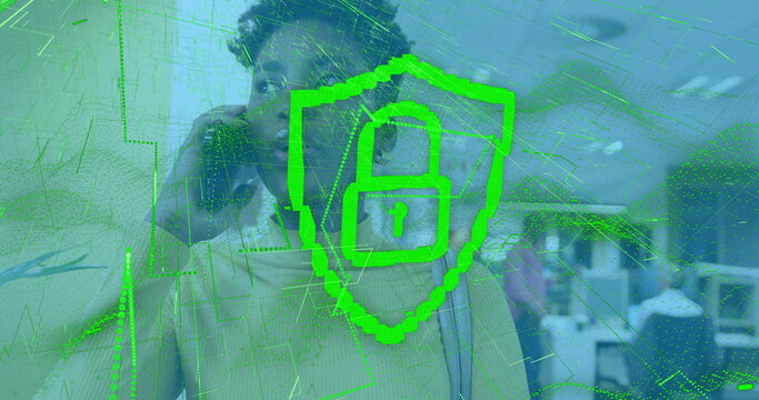 Image of digital padlock over african american woman in office having call