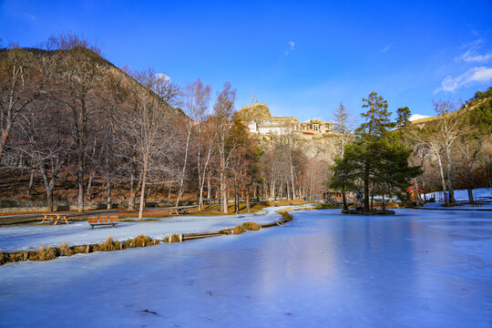 Frozen lake of the Parc de la Schappe overlooked by the Vauban citadel of Brian&ccedil;on, a small town of the Hautes-Alpes department in the French Alps