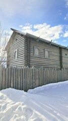 Wooden boards, fence, wooden house, natural materials, logs, beams, gates, winter in the village