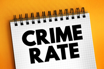 Crime Rate is the ratio between the number of felonies and misdemeanours recorded by the police, text concept on notepad