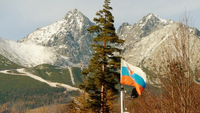 Tricolor flag of Slovakia on the background of Lomnicky stit in the High Tatras mountain system.