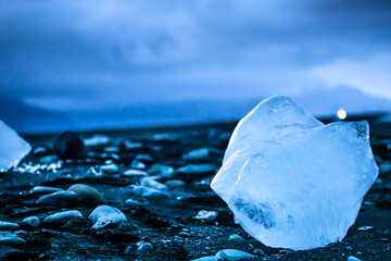 Ice cube lost by ocean on a black beach. Diamond Beach Iceland