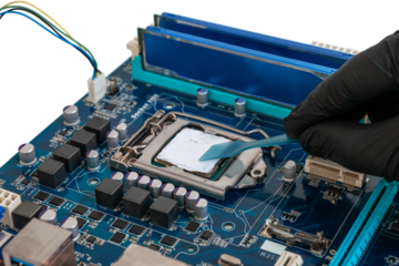 Engineer applies thermal paste to a processor installed in a socket on a printed circuit board. Computer equipment maintenance concept, cut out
