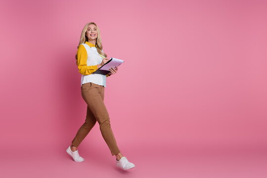Photo of lovely cute gorgeous woman wear stylish clothes go office empty space isolated on pink color background