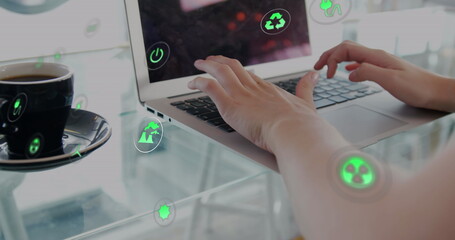 Image of multiple icons over coffee cup and midsection of caucasian woman working on laptop