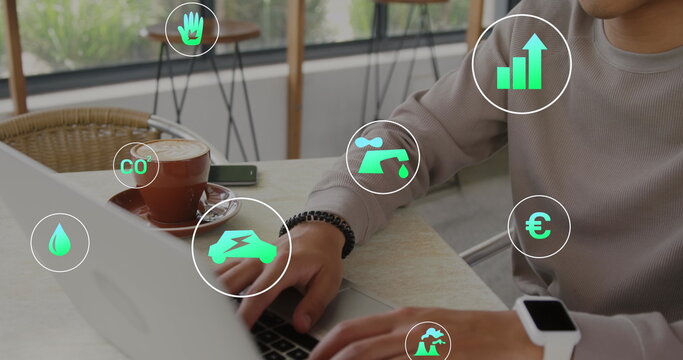 Image of multiple icons over biracial man working on laptop in cafes