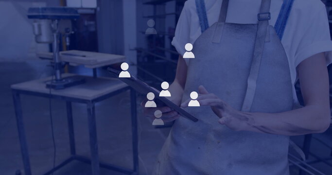 Image of network of connections with icons over caucasian male doctor using tablet