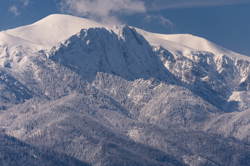 Giewont mountain and Tatra peaks, Poland winter scenercy covered snow. Blue cloudless sky. View...