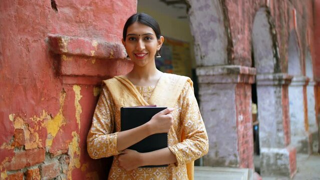 Beautiful Indian female assistant professor - college student  school girl  young graduate  nari shakti  studious girl. A young school teacher smiling bright outside a government school - teaching ...