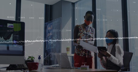 Image of financial data processing over diverse business people wearing face masks