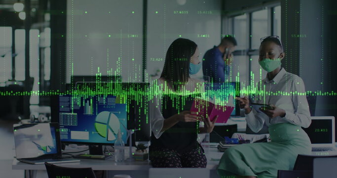 Image of financial data processing over diverse business people wearing face masks