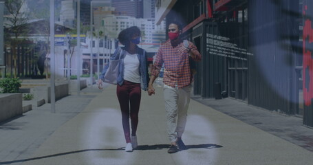 Image of social media icons over african american couple holding hands walking on the street