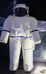 The cosmonaut's costume is vertical on a dark background.
