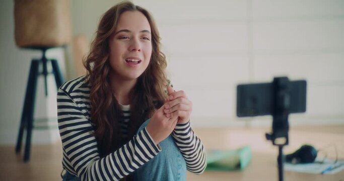Beautiful female content creator recording herself talking