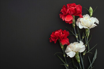 Carnation flowers with candle on black background. Copy Space. Generative AI.