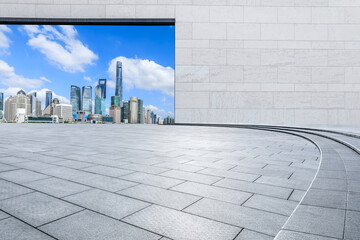 Fototapeta premium Empty square floor and brick wall with city skyline in Shanghai