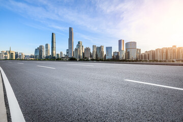 Asphalt highway road and modern city buildings at sunset in Guangzhou