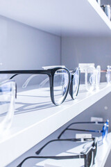 exhibitor of glasses consisting of shelves of fashionable glasses shown on a wall at the optical shop
