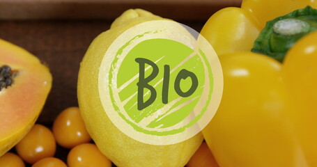 Image of bio text banner against close up of variety of fruits on wooden table