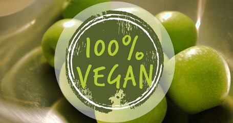 Image of 100 percent vegan text banner against close up of green apples
