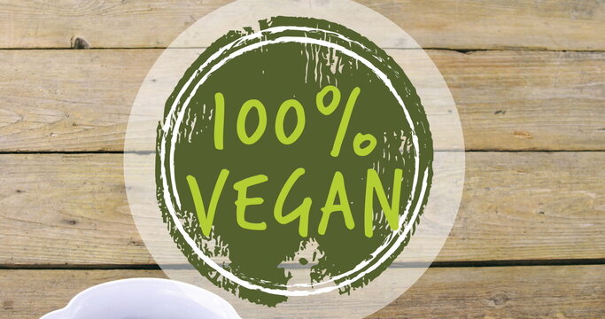 Image of 100 percent vegan text over bowl of fresh fruit