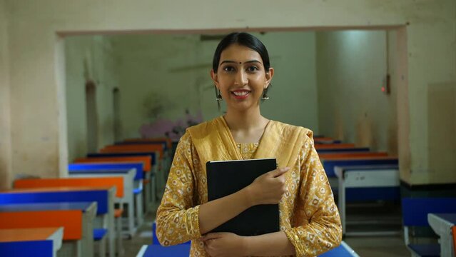 Beautiful young Indian girl in traditional wear excited for her first day at college - topper  university topper. Mature adult female from village area all set for a new life in university - studio...