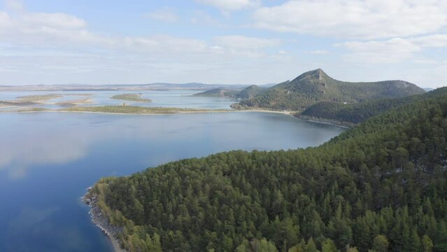 Aerial drone footage of rock remnant near the Lake Great Chebachye Lake in Natonal park Burabay Borovoe , Kazakhstan