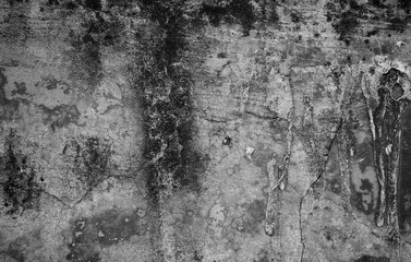 A weathered concrete wall with cracks and peeling paint, showing signs of age and decay.