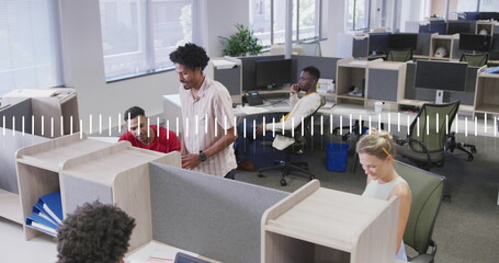 Image of lines forming graph over diverse coworkers discussing on desk in office