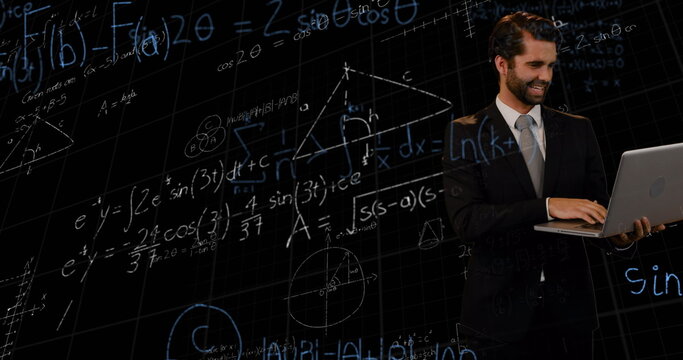 Mathematical equations floating against caucasian businessman using laptop against black background