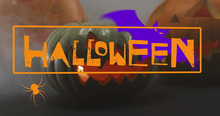 Image of happy halloween text with bat and spider over carved pumpkins