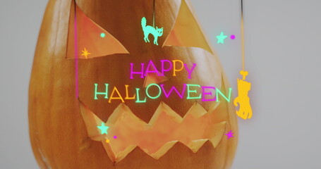 Fototapeta premium Neon happy halloween text banner over halloween scary pumpkin against grey background