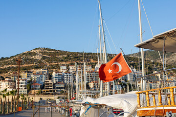 Turkish flag waving in marina breeze