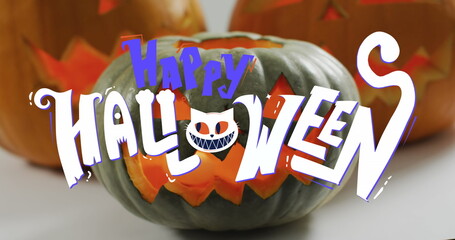 Happy halloween text banner against halloween pumpkins on white background
