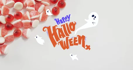 Foto op Plexiglas Happy halloween text banner and ghosts icons against close up of candy corns on white surface © vectorfusionart