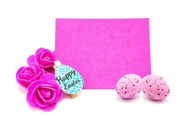 Pink blank greeting card with rose flowers with colored eggs. Copy space. Free space for text. Happy easter!	